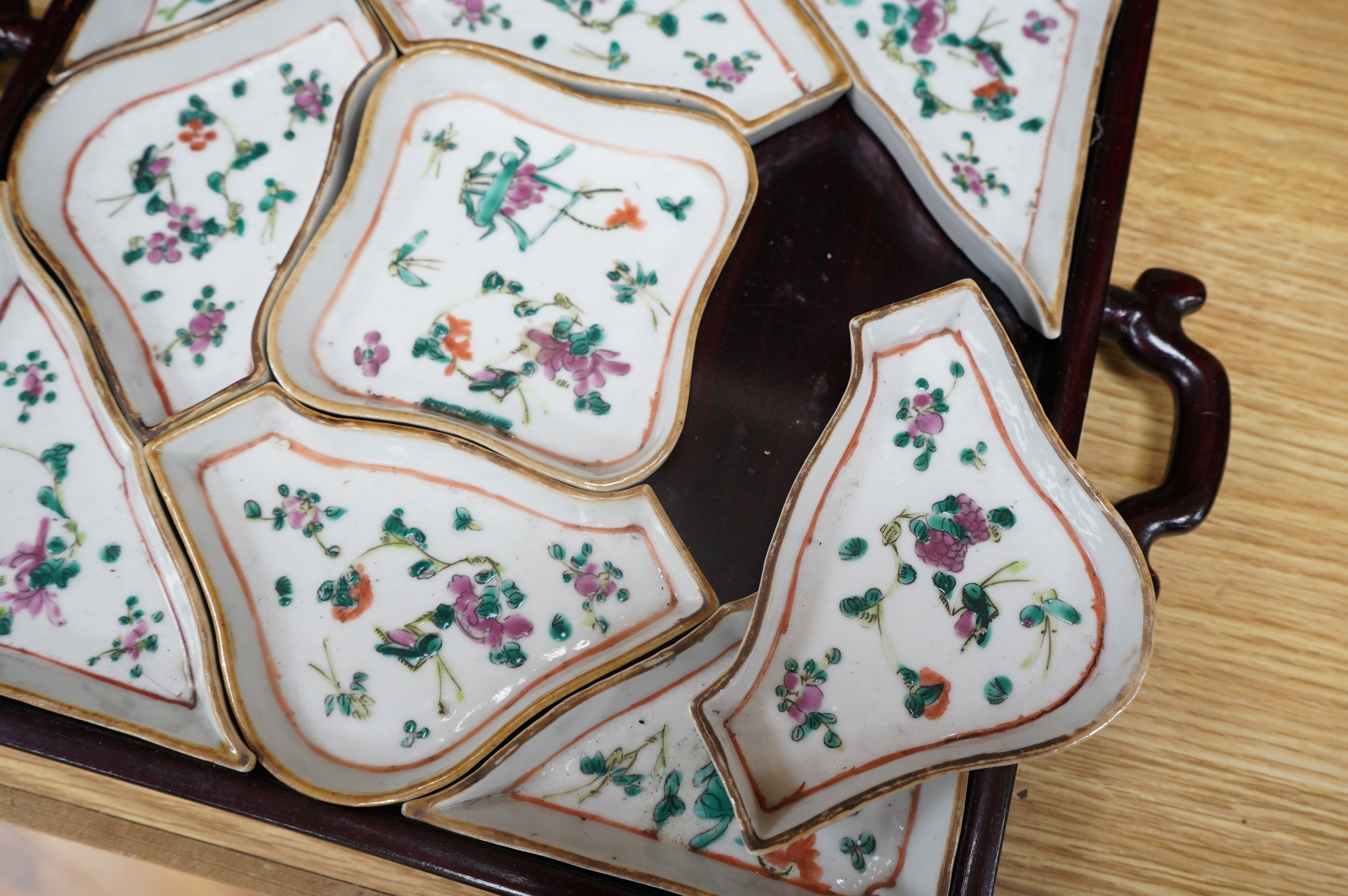 A square Chinese hardwood tray of famille rose geometric dishes, 30cm. Condition - fair to good